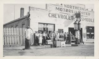 Staff standing in front of the "Northern Motors Limited" g… | Flickr