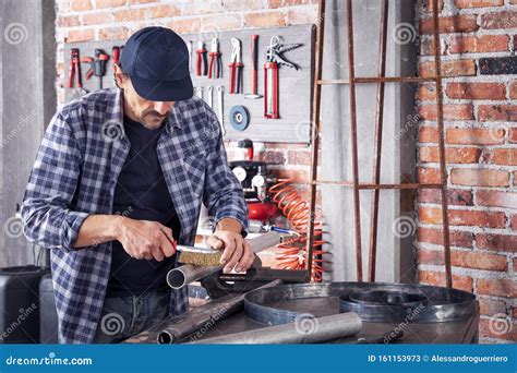 Metalworker Cleaning Off a Metal Pipe with a Brush Stock Image - Image ...