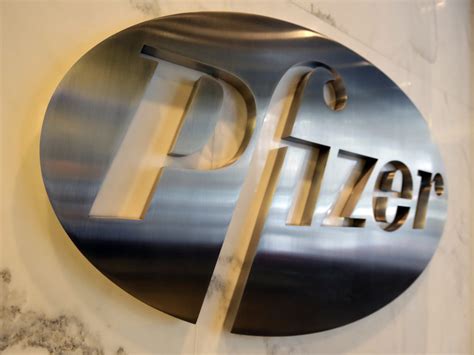 The Pfizer company logo displayed at Pfizer Inc. headquarters, in New ...