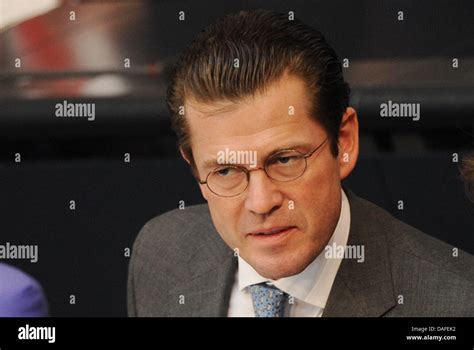 German Minister of Defence Karl-Theodor zu Guttenberg makes a face during a question time of ...