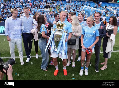 Manchester City's Erling Haaland celebrates with the Premier League trophy with family and ...