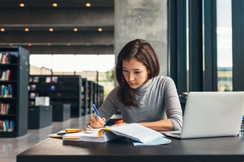 Female student studying at college library - New Hampshire Women's Foundation