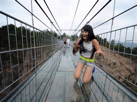 High-altitude suspension bridge made of glass opens in Hunan, China