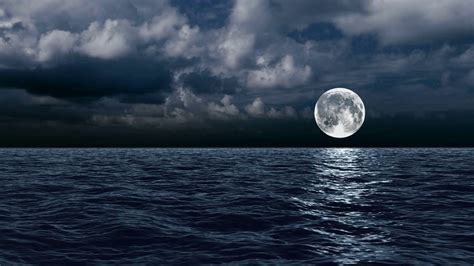 The moon over the sea in the clouds Motion Background - Storyblocks