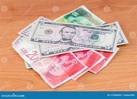 United States Dollar And Israeli New Shekel Banknotes On Wooden Table ...