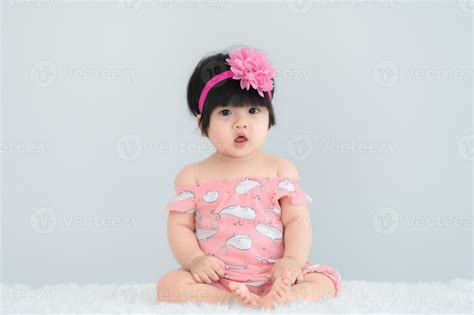 Portrait of cute asian baby on white carpet,Newborn smile for take a ...