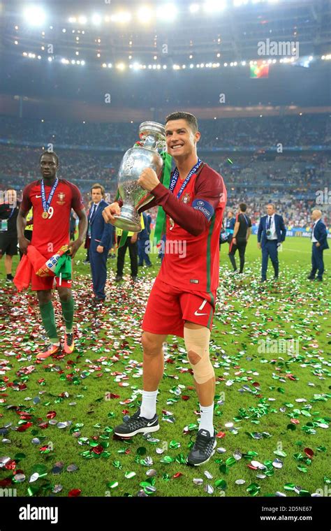 Portugal's Cristiano Ronaldo celebrates with the trophy on the pitch ...