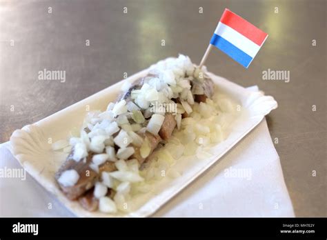 Traditional dutch food: herring fish with onion in fastfood market of Amsterdam, Netherlands ...