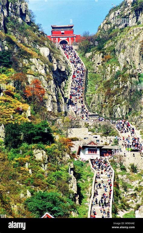 Tourists climb Mountain Tai or Taishan Mountain in snow in TaiAn city ...