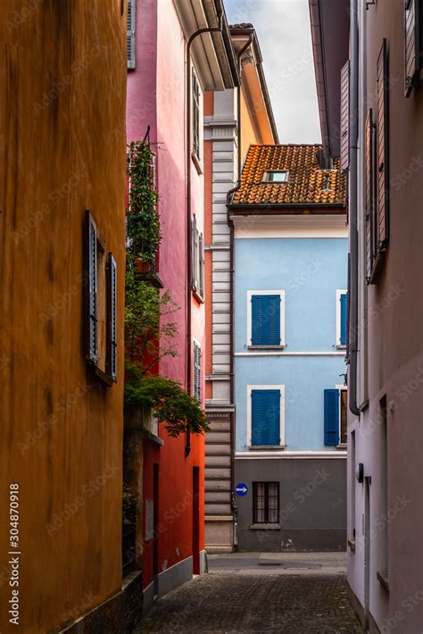 Colorful houses lined along a picturesque cobbled alley in Locarno old town, Canton Ticino ...