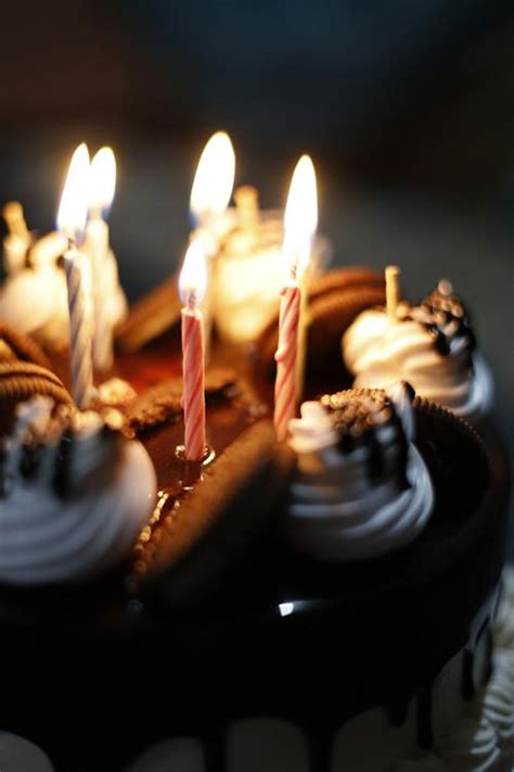 A Close-Up Shot of a Chocolate Cake with Lighted Candles · Free Stock Photo