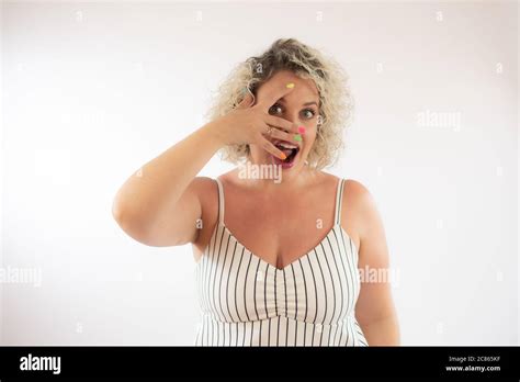 Blonde young woman making funny hand gestures Stock Photo - Alamy