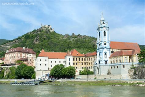 The view of Durnstein Abbey by Danube River with castle ruins on a top ...