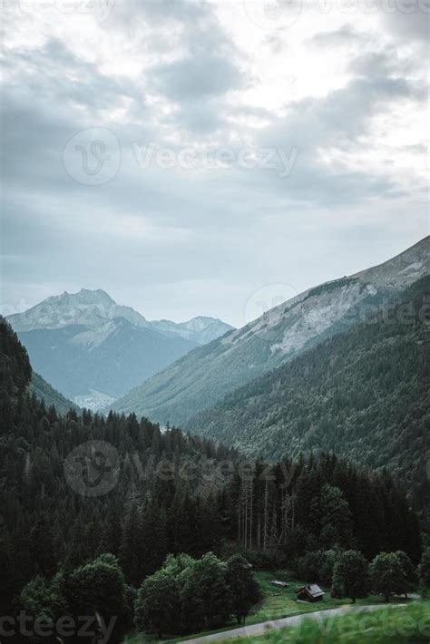 Majestic mountains in the Alps covered with trees and clouds 20487762 Stock Photo at Vecteezy