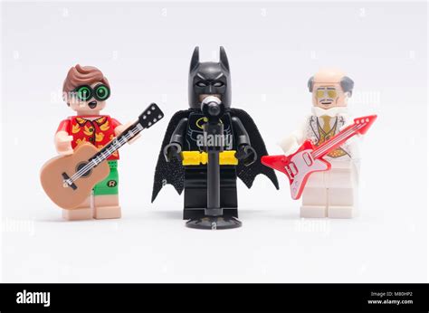 lego batman singing with alfred and robin play the guitar. isolated on ...