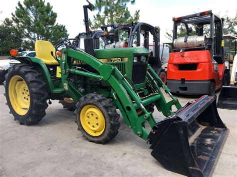 JOHN DEERE 750 TRACTOR WITH BUCKET ATTACHMENT, 1,042 HOURS SHOWING, DIESEL, RUNS AND OPERATES