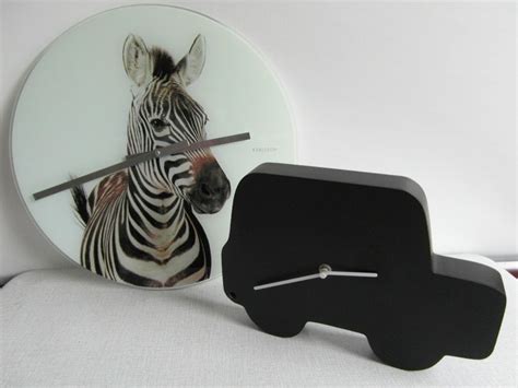 Karlsson - Two Karlsson Wall Clocks - Glass and Wood - Catawiki