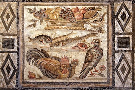 an old mosaic with birds and other animals on it's side, in the middle of