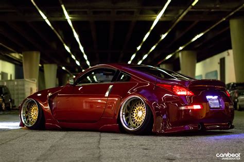 a red sports car parked in an underground parking garage with lights ...