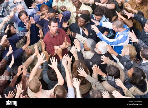 Young man surrounded by crowd Stock Photo - Alamy