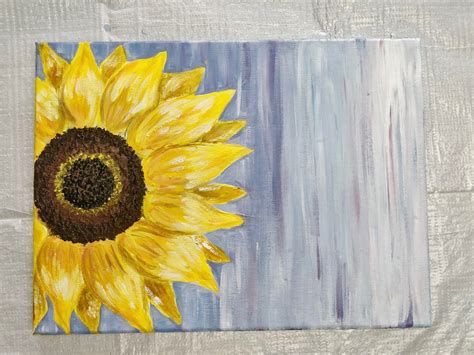 a painting of a sunflower on a blue and white background