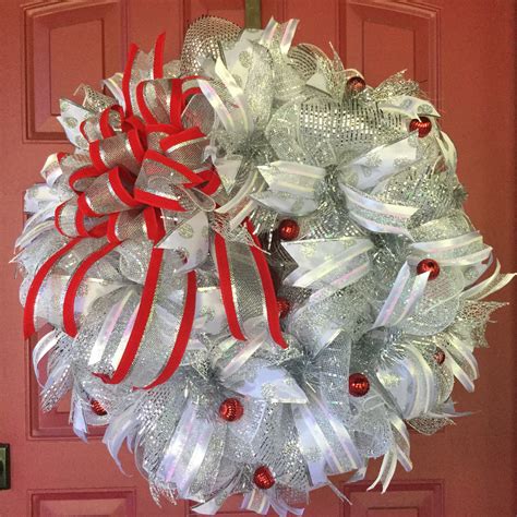 a christmas wreath with red and white bows