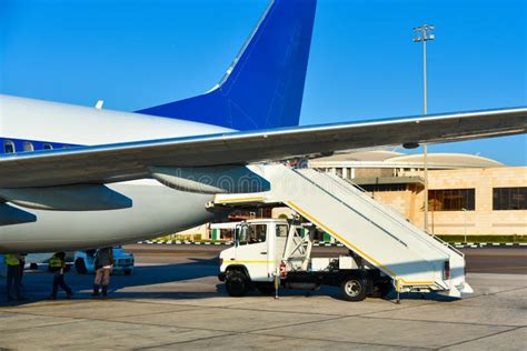 Disembarkation of Passengers from an Airplane at an African Airport ...