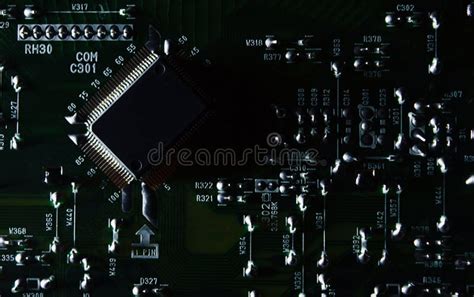 Part of an Electronic Circuit Board with a Microcircuit and Electronic Components in a Low Key ...