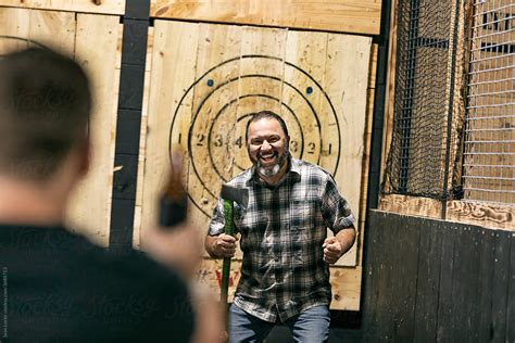 "Excited Man Gets Beer Cheers From Friend" by Stocksy Contributor "Sean ...