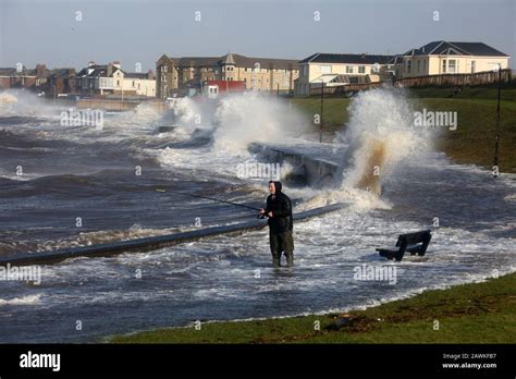 Scotland, Ayrshire, Prestwick, Storm Ciara 02 Feb 2020 A lone fsherman angler battles waves ...