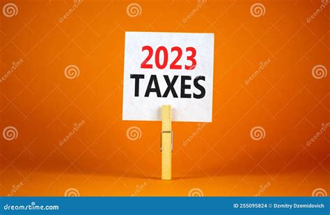 2023 Taxes New Year Symbol. White Paper with Words 2023 Taxes, Clip on Wooden Clothespin Stock ...