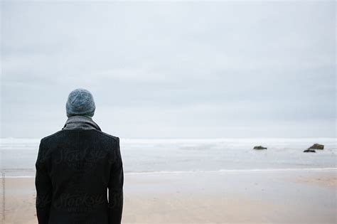 "Man Standing Alone On The Beach Looking Out To Sea" by Stocksy Contributor "Suzi Marshall ...