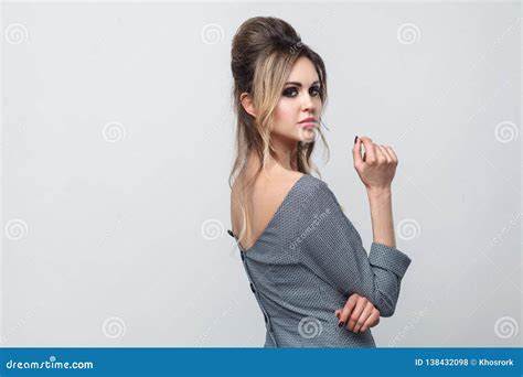 Side Profile View Portrait of Beautiful Attractive Fashion Model in Grey Dress with Makeup and ...