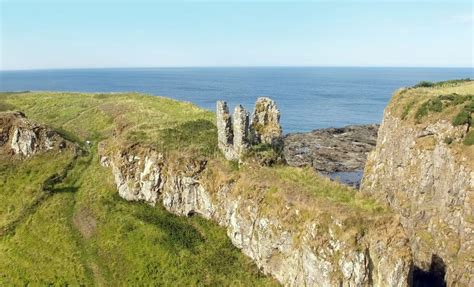 Ruins Of Dunseverick Castle Atop Green Cliffs Of The Causeway Coast ...