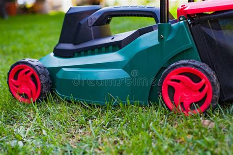 Lawn mower in the backyard stock photo. Image of ground - 99655852