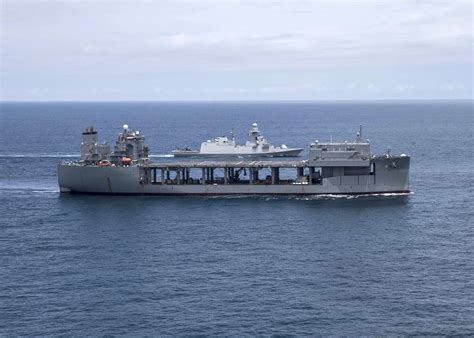 The expeditionary sea base USS Hershel “Woody” Williams (ESB 4), front, conducts a tracking ...