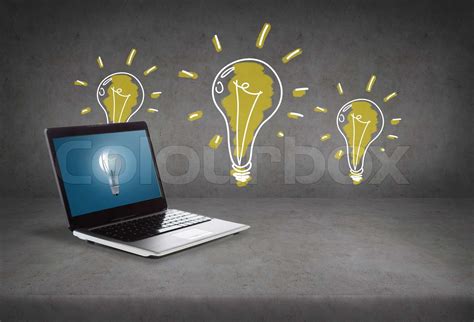 laptop computer with light bulb on screen | Stock image | Colourbox