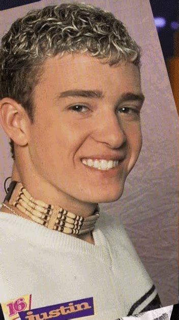 a close up of a person wearing a sweater and smiling at the camera with ...