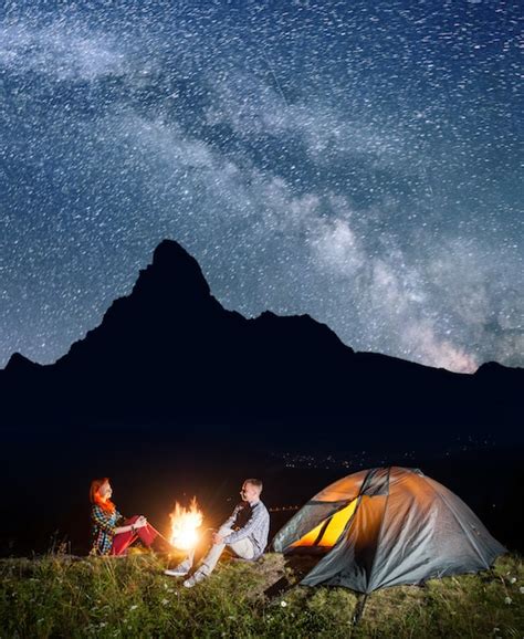 Premium Photo | Night camping. happy couple backpackers sitting by ...