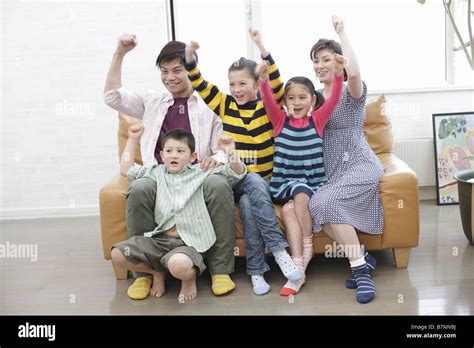 Family watching sports program Stock Photo - Alamy