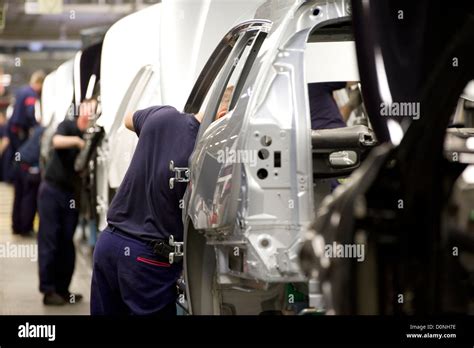 car factory workers on motor vehicle assembly line Stock Photo - Alamy