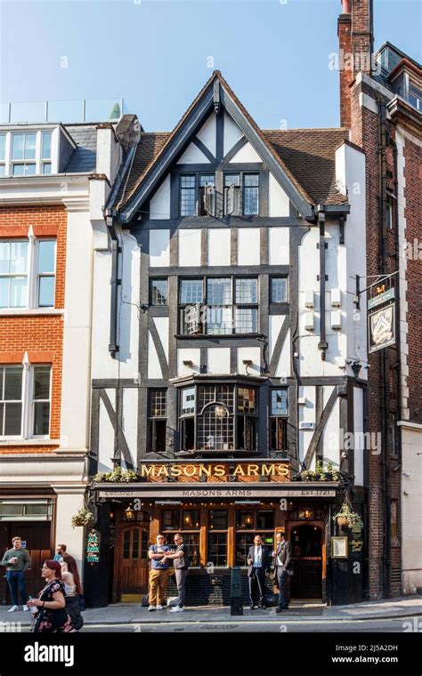 Drinkers outside the Masons Arms public house in Maddox Street, in the ...