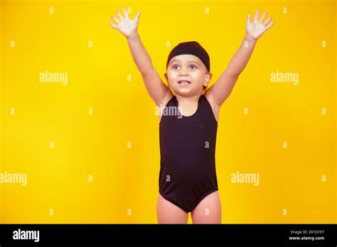 Little girl wearing beach outfit on yellow background. Summer and ...