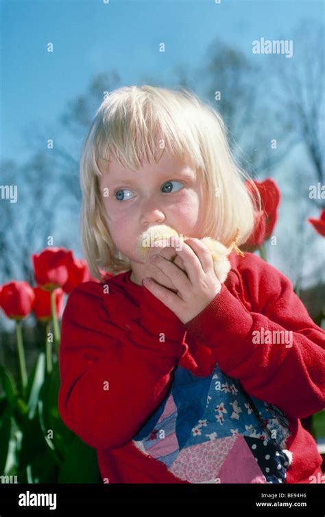 Kissing chicks: Young girl holding a baby chick sneaks a kiss, Midwest USA Stock Photo - Alamy