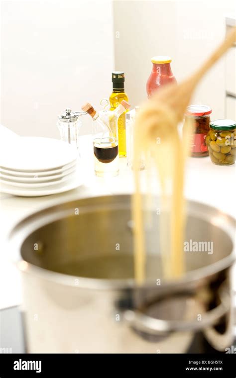 Woman boiling pasta Stock Photo - Alamy