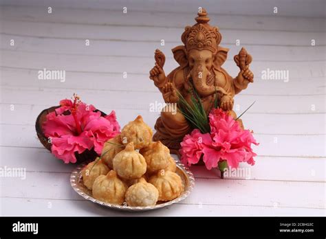 Ganesh Puja - Sweet Modak food offered on Ganpati festival or Chaturthi in India. in silver ...