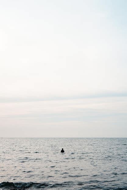 Premium Photo | Minimalist photo of a man alone on the beach. lonely on the beach.