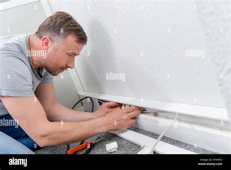 Fixing a wall socket Stock Photo - Alamy