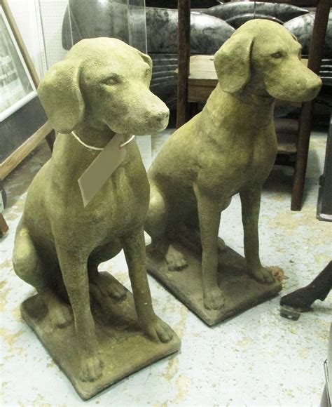 GARDEN DOG STATUES, a pair, 19th century 'Cotswold stone' style, in weathered finish, 75cm H x ...