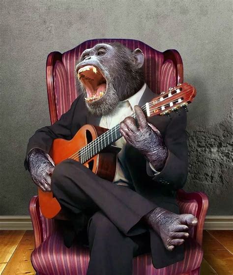 a monkey sitting in a chair holding a guitar and singing into the ...